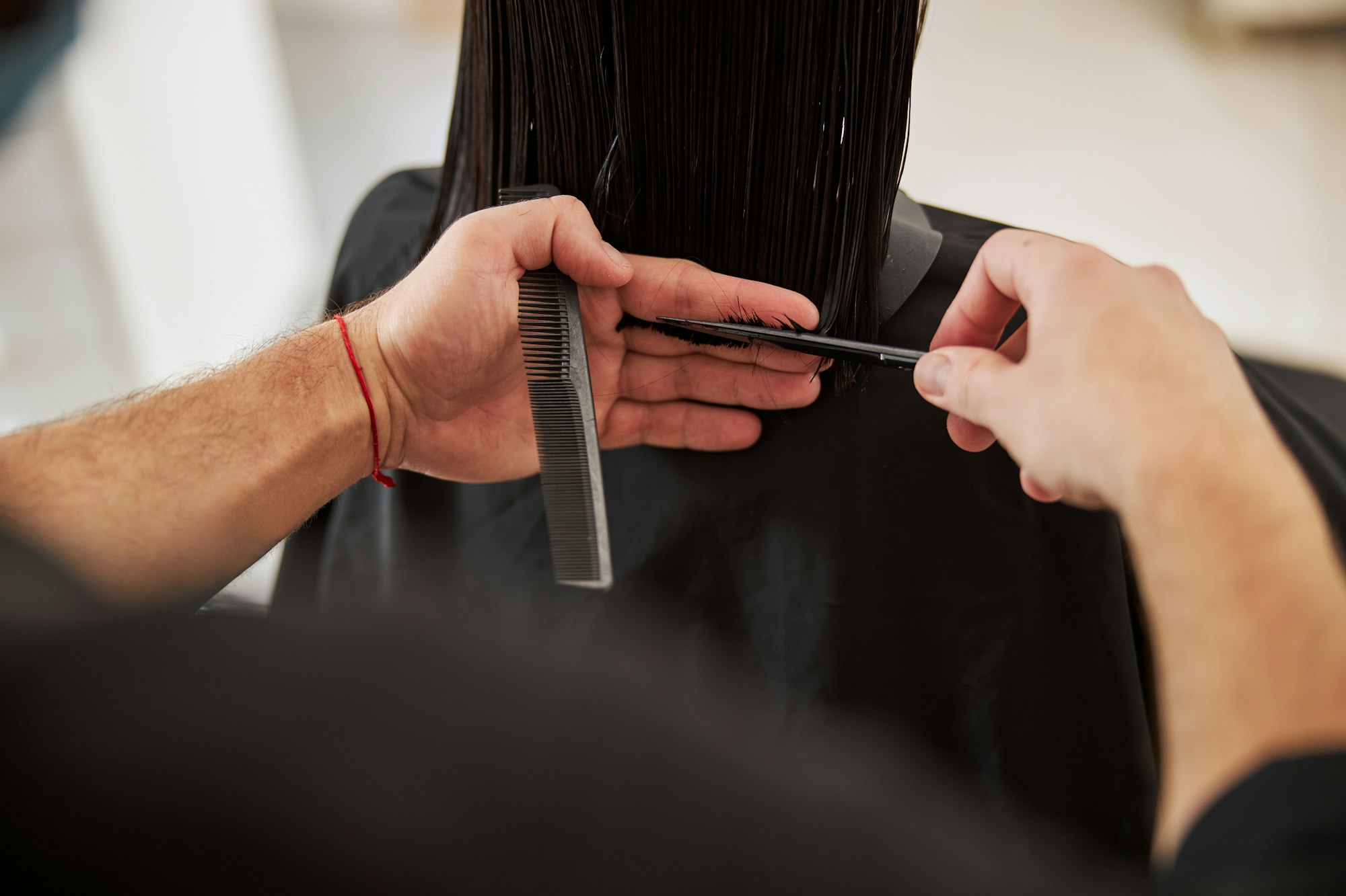 Customer having her hair cut by a salon professional